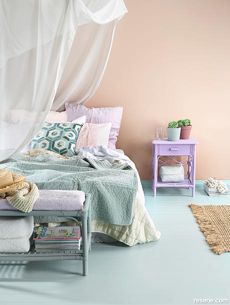 A bedroom with peach walls and a light blue floor