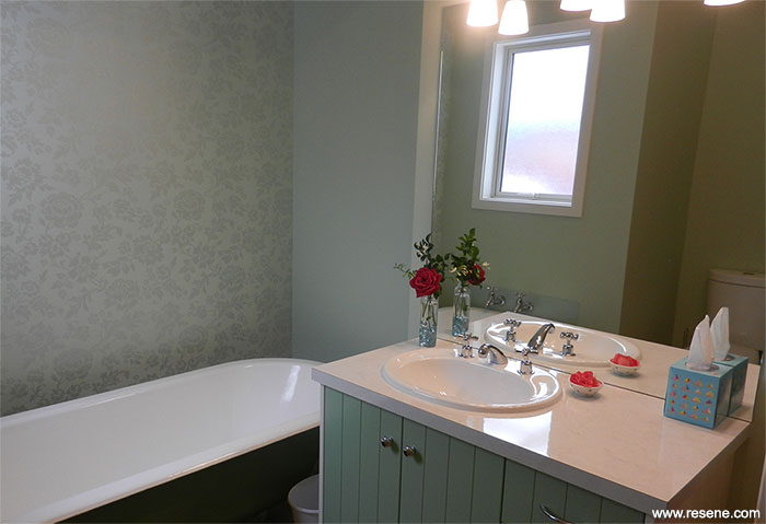 Resene Pale Leaf on walls, Resene Norway on the vanity front and Resene Highland for the body of the bath