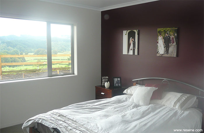 The bedroom is finished in Resene Eighth Napa with a feature wall in Resene Red Earth