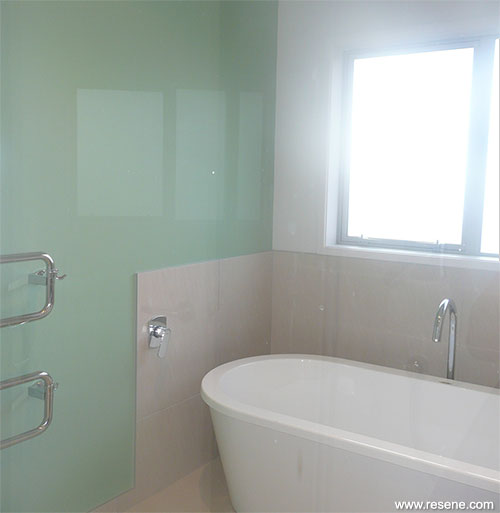 The main bathroom is finished in Resene Eighth Napa with a feature wall in Resene Seagrass 