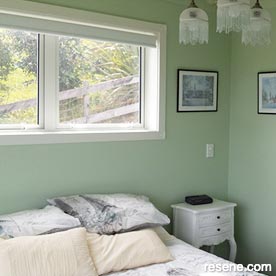 Light green and white guest room