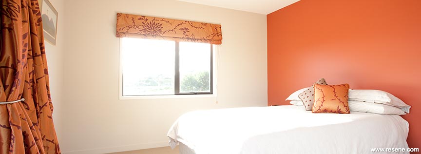 Bright orange and neutral bedroom