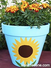 Paint a sunflower plant pot.