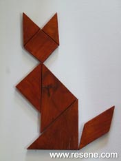 Create a classic wooden tangram puzzle of a cat