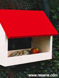 A roofed bird feeder to keep the food dry and provide shelter for the birds while feeding