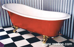 A red freestading clawfoot bath from The Bath range by Burmark.