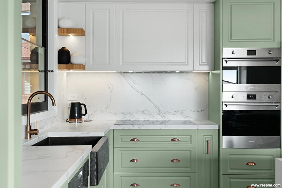 A white and green kitchen