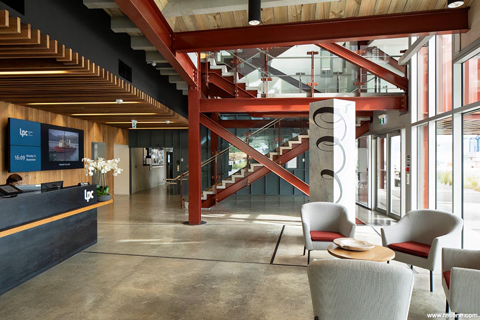Red exposed structural steel in office lobby