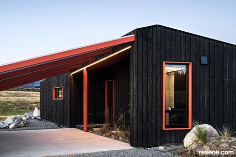 A black and burnt orange cabin exterior