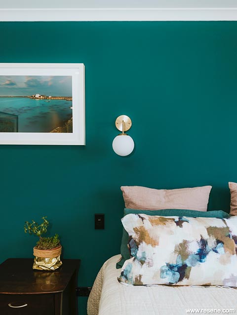 Master bedroom with bold blue green wall
