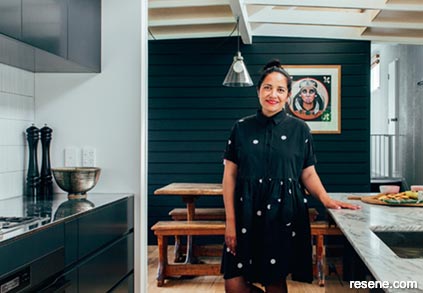 Emily Legget at home with her dark black and white kitchen