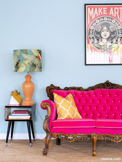 Blue lounge with dramatic pink couch