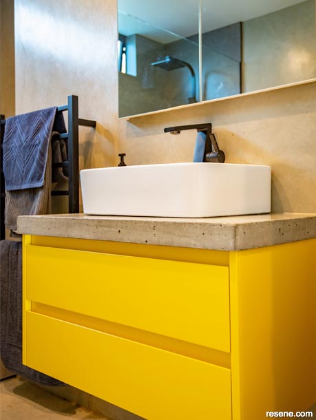 Vibrant yellow cabinetry features in this bathroom