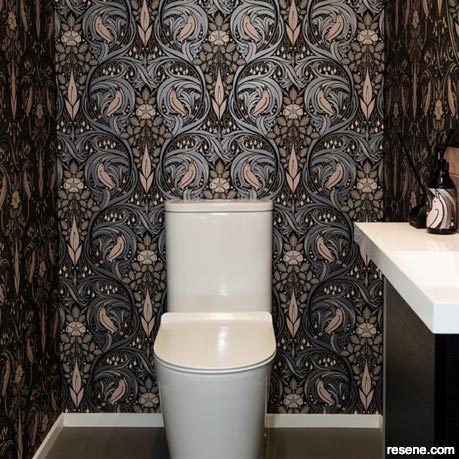 Whimsical wallpaper features in this powder room