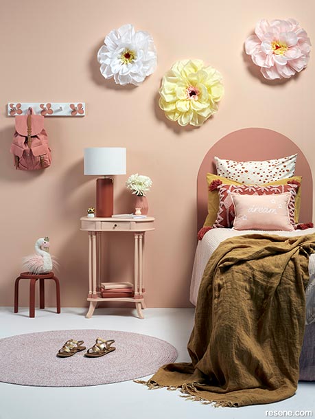 A bedroom with pinky apricot tones