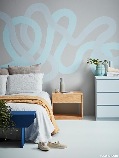 A relaxing bedroom with painted swirls on the walls