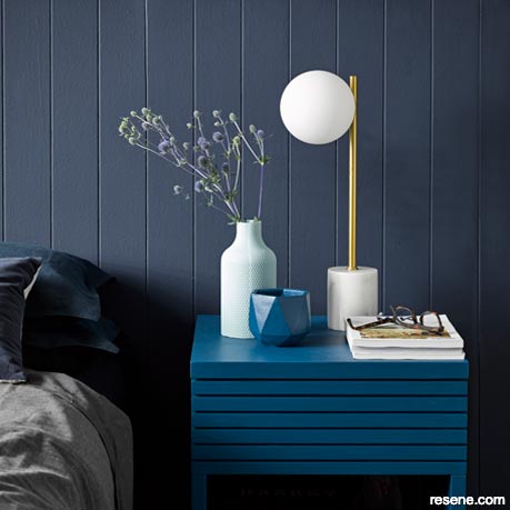 A deep blue and moody grey bedroom