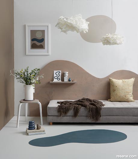 A reading corner with curved shapes and creamy and earthy tones