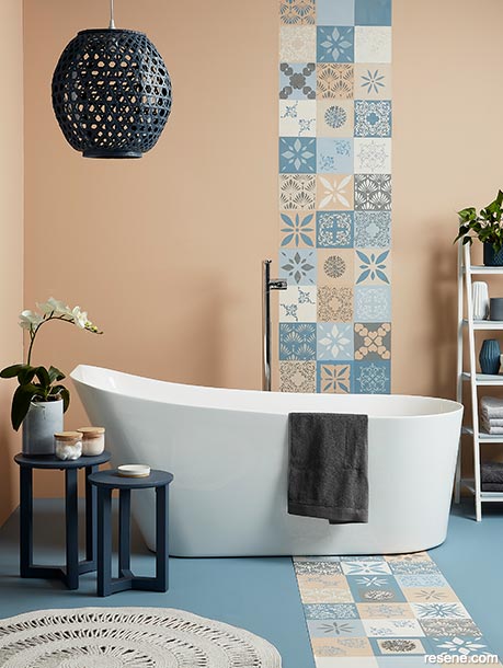 A serene bathroom painted in powdery pastel blue and gentle coral