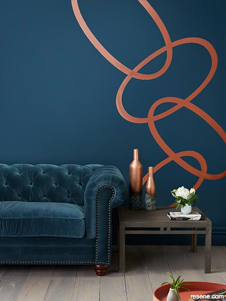 A dark blue lounge with a painted metallic swirl