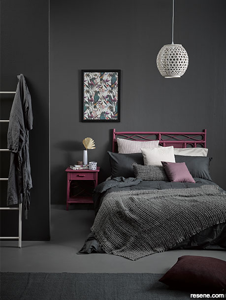 A charcoal bedroom with magneta accents