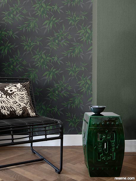 A seating area with bamboo-themed wallpaper