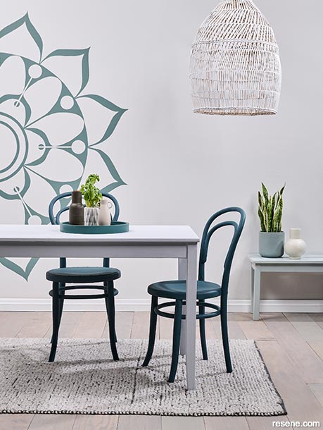 A dining room with a mandala painted on wall