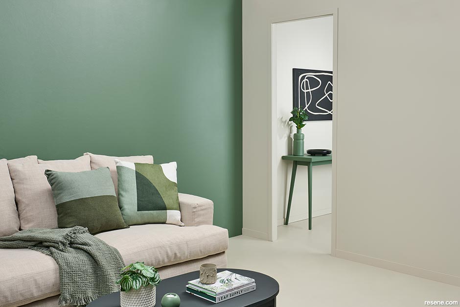 A lounge with a wall painted in lush green