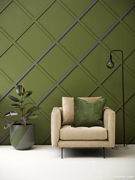 A green sitting room with diagonal battens