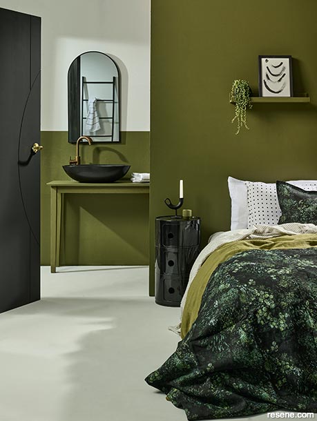 A mossy green bedroom with black accents