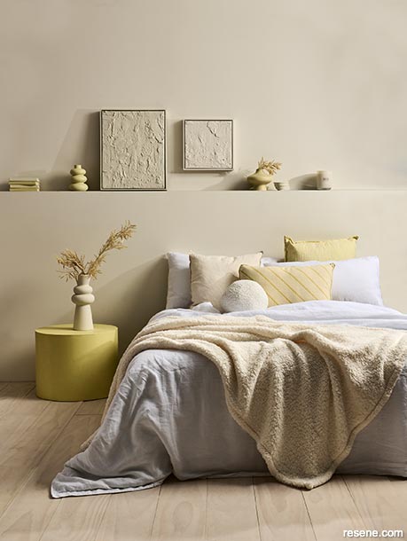 A creamy yellow bedroom with bursts of sunshine brights