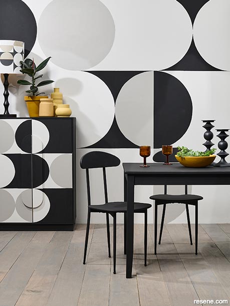 A dining room with bold circular wall patterns