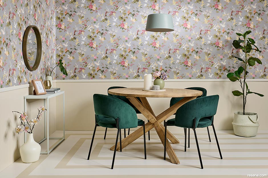 A dining room with a floral patterned wallpaper