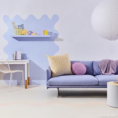 A lounge with a soft lilac feature wall