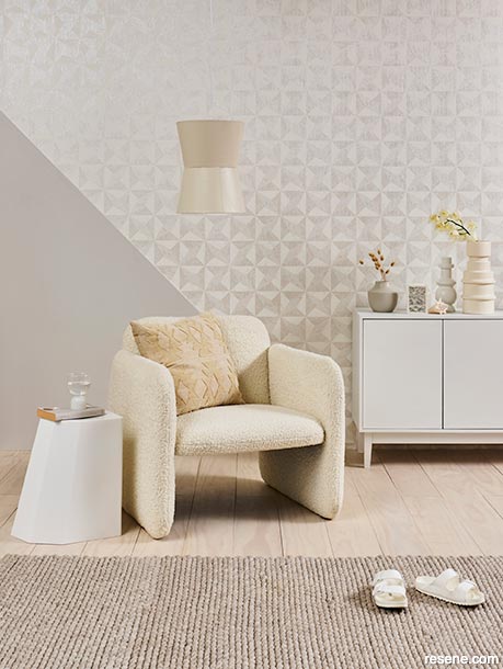 A sitting room with a geometric wallpaper design