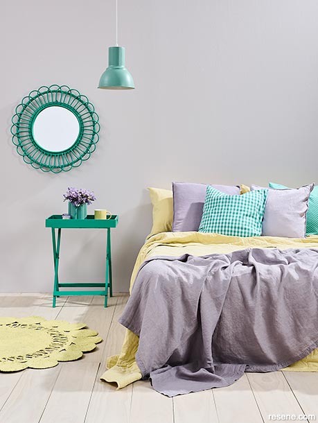 Greens, lilacs and yellow elevate this neutral bedroom