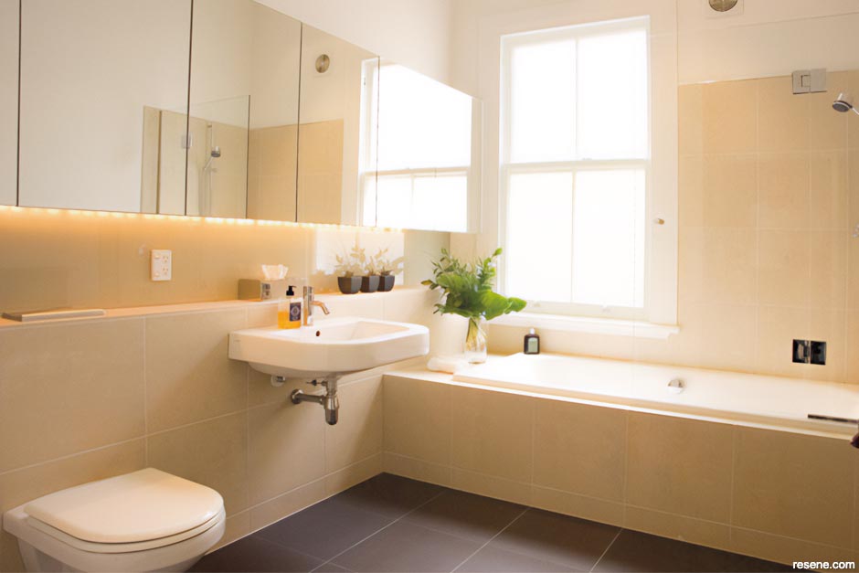 Sandstone-look tiles provide a luxury finish in this bathroom