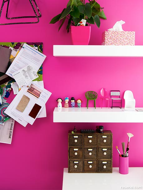 A pink home office with white shelving