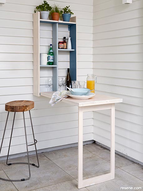 A fold-down outdoor barbecue storage table