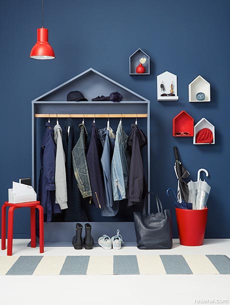 A dark blue entryway with red accessories