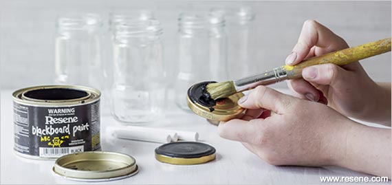 Painting the lids with blackboard paint