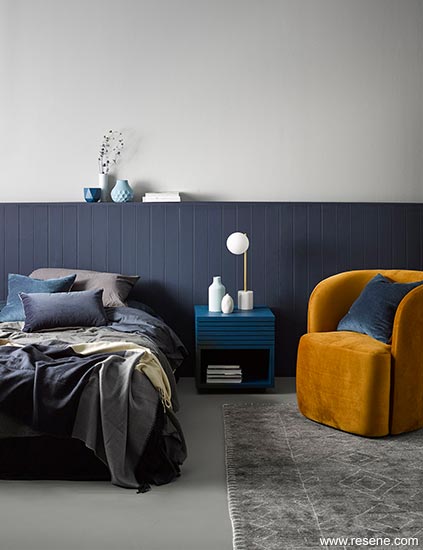A sophisticated master bedroom layering cloudy greys and moody blues