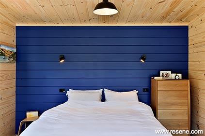 Whitewashed timber with a bold statement wall in blue