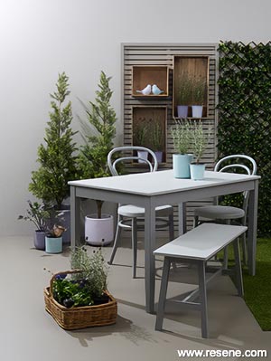 A grey outdoor space with purple accessories