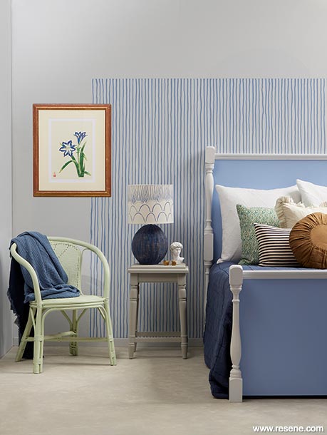 Bedroom with blue and white pinstriped wall 