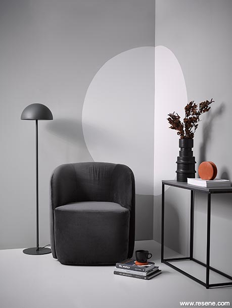 A lounge with greyscale styling and brown accessories