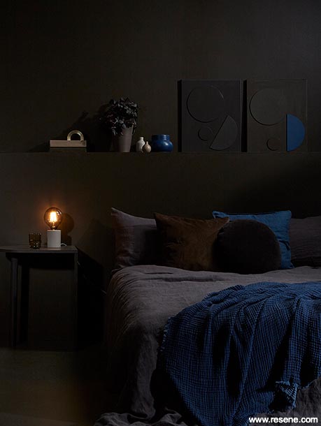 A chocolate brown bedroom with blue accessories