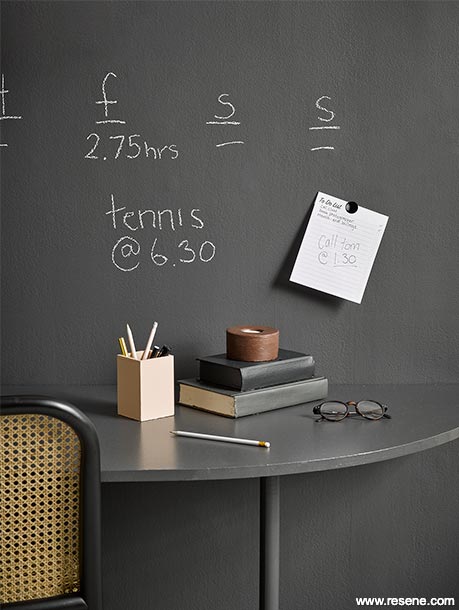 A home office with blackboard paint walls