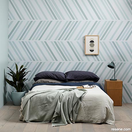 Bedroom with tonal blue embedded arrow pattern 