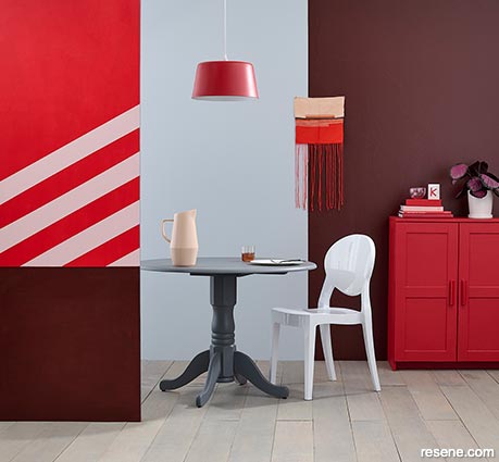 A dining room with burgundy and red feature walls 2